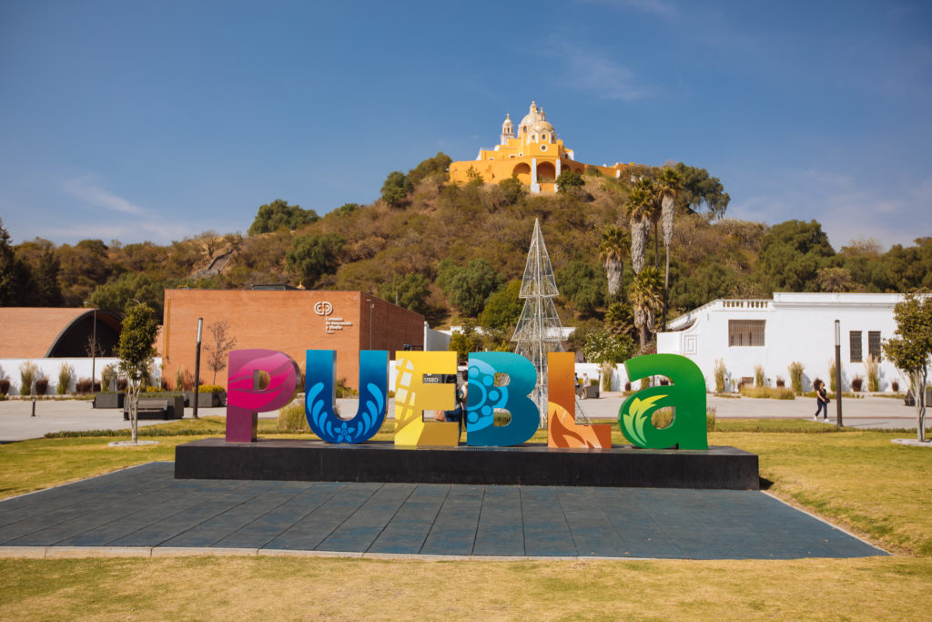 Schriftzug "Puebla" vor Pyramide Cholula